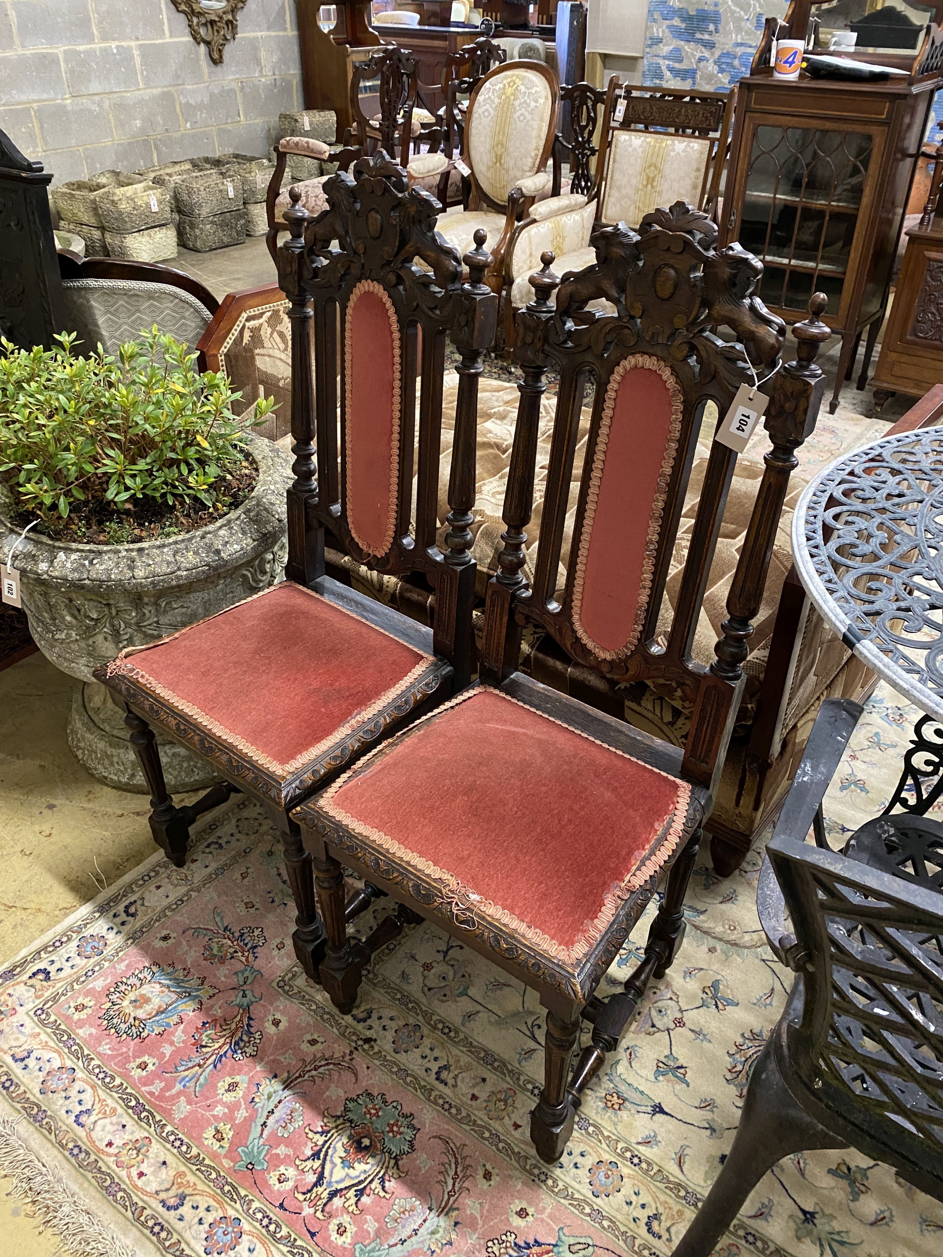A pair of late Victorian carved oak dining chairs
